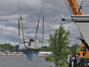 The crew from Lakeshore Crane lower one of 80 sailboats from the Bay of Quinte Yacht Club into the water at Victoria Harbour on the weekend.
TIM MEEKS
