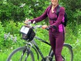 Guylaine Lanthier, a participant in Sunday's online Walk for Alzheimer's, pauses during her cycling tour of lilac bushes Saturday in Prince Edward County. The Alzheimer Society volunteer did both the tour and online event in memory of her mother, who had dementia.