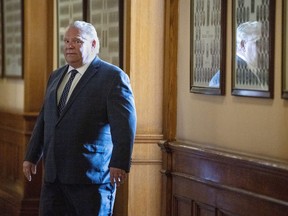 Premier Doug Ford leaves his office at Queen's Park to deliver his daily press briefing.
CANADIAN PRESS