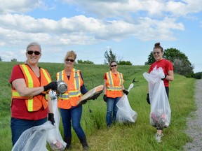 Stirling Rotarians, Lianne Radocsay (left) has unearthed a vehicle's centre cap while Trish Clarke holds a discarded headlight assembly. Just two of the items picked up along the five kilometres stretch of Highway14 immediately north Stirling last Thursday evening as volunteers Kim Caron and Megan Radocsay look on. This foursome did their part as two-dozen Rotarians and student volunteers filled more than 30 extra-large plastic bags with litter during the service club's semi-annual Adopt-a-Road clean-up program established in 2017. 
TERRY VOLLUM