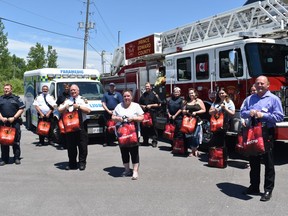 Firefighters and paramedics in Prince Edward County were presented with 170 Bags of Hope care packages Friday in Picton for the critical work they do keeping their community safe. DEREK BALDWIN
