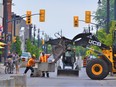 A heavy-equipment crew placed large concrete blocks along the middle of Front Street in BellevilleÕs Downtown District Saturday in preparation for Al Fresco on Front celebrations July 10 to September 30 as part of the Downtown District Business Improvement AreaÕs plan to draw pedestrians to the historic city core as residents emerge from pandemic hibernation. DEREK BALDWIN
