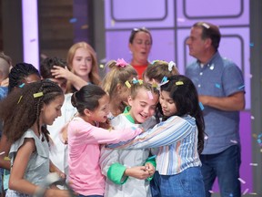 Audrey MacKinnon is hugged after winning the finale of the Junior Chef Showdown TV program. Courtesy Food Network Canada