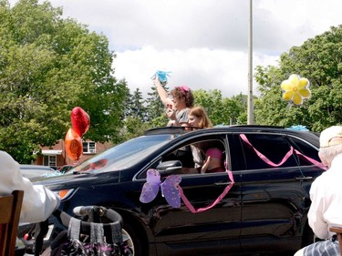 Sandi Stackhouse-Beauregard and her daughter, Paige Mathieson, wave to Sandi's mom, Pat Stackhouse. (RONALD ZAJAC/The Recorder and Times)