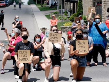 Demonstrators take a knee, in solidarity with the Black Lives Matter movement, in front of Brockville city hall. (RONALD ZAJAC/The Recorder and Times)
