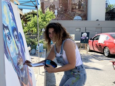 Local artist Mary-Louise Scappaticci paints a portrait of Will Smith Saturday afternoon as Brockville takes part in the National Arts Drive, an effort to reconnect artists with the public amid the COVID-19 pandemic. She was one of eight artists taking part in the event, including Caroline Hosick, whose work is seen in the background. (RONALD ZAJAC/The Recorder and Times)