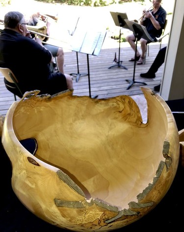 A brass band plays in the background as one of woodturner Lance Besharah's creations is on display. (RONALD ZAJAC/The Recorder and Times)