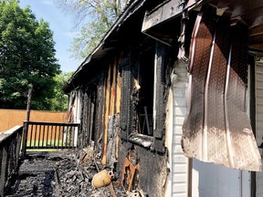 The charred remnants of a back deck are seen on Tuesday morning on Bisley Crescent after a fire tore through the home earlier that morning. (RONALD ZAJAC/The Recorder and Times)