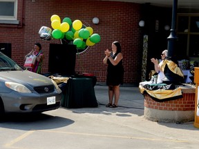 South Grenville District High School staff greet Grade 12 student Audrey Waterworth as she makes her way through a drive-through graduation event at the Prescott school on Tuesday. (TIM RUHNKE/The Recorder and Times)