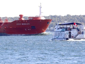 The Sea Fox II of 1000 Islands Seaway Cruises heads toward the Sten Bergen to give passengers a close look at the laker as she passes through the St. Lawrence River seaway. File photo