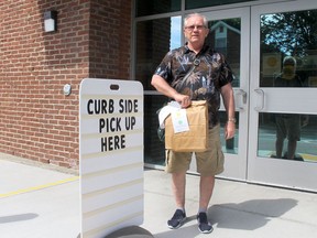 Helmut Pawlak, of Chatham, was the first person to use the curbside pick up that was first offered at the Chatham branch of the Chatham-Kent Library as a safety measure to protect against the spread of the COVID-19 pandemic. (Ellwood Shreve/Postmedia Network)
