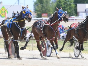 Master Element, left, Nates Bucky and Scout Says run down the homestretch during the fifth race at Dresden Raceway's season opener in Dresden, Ont., on Sunday, June 7, 2020. Mark Malone/Chatham Daily News/Postmedia Network