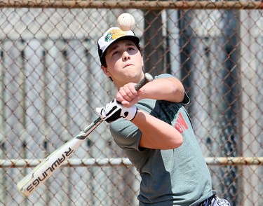 Owen Graham, 14, takes a swing during a family baseball outing at Blythe Park in Chatham, Ont., on Monday, June 15, 2020. Mark Malone/Chatham Daily News/Postmedia Network