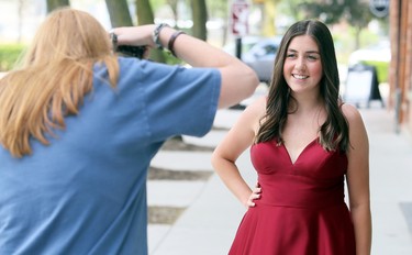 Hunter Twigg, right, poses for photographer Ella Dam in downtown Chatham in Chatham, Ont., on Friday, June 26, 2020. Dam was taking photos for FreeHelpCK's drive-up prom for Grade 12 students whose school prom was cancelled because of the COVID-19 pandemic. Twigg is in Grade 12 at Ursuline College Chatham. Mark Malone/Chatham Daily News/Postmedia Network