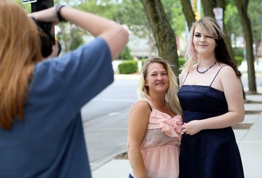 Tristan Reaume, right, and her mother, Retta Cadotte, pose for photographer Ella Dam in downtown Chatham in Chatham, Ont., on Friday, June 26, 2020. FreeHelpCK was holding a drive-up prom for Grade 12 students whose school prom was cancelled because of the COVID-19 pandemic. Reaume is in Grade 12 at Ursuline College Chatham. Mark Malone/Chatham Daily News/Postmedia Network