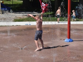 A group of local kids cool off in the recently re-opened splash pad in Clinton. Daniel Caudle