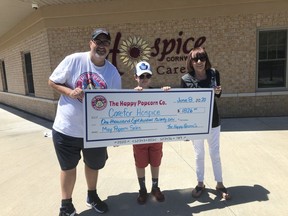 Handout Not For Resale
Happy Popcorn Co. co-owner Bill Halman and his son Jack recently presented a $1,826 donation to Carefor Health and Community Services fundraising coordinator Sandy Colette. Handout/Cornwall Standard-Freeholder/Postmedia Network