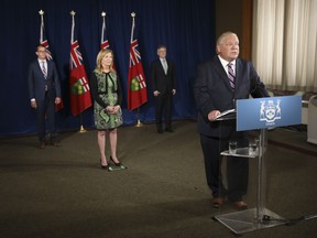 Ontario Premier Doug Ford holds his daily press conference at the Ontario Legislature at Queen's Park, Monday, June 22, 2020, joined by Christine Elliott, Deputy Premier and Minister of Health, Rod Phillips (right), Minister of Finance, and Monte McNaughton, (left) Minister of Labour, Training and Skills Development. THE CANADIAN PRESS/Richard Lautens