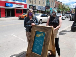 Morag Budgeon, left, executive director of the Georgian Bay Centre for the Arts, and employee Kailey Lang stand on part of the boulevard that the centre hopes to turn into a sidewalk patio for its Palette Cafe. The two parking spaces next to Budgeon would also be part of the patio if the city approves the centre's application. DENIS LANGLOIS