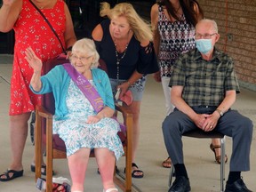 Doris Kierstead waves to well-wishers on her 100th birthday. Niece Laurie Bramer and her 'baby brother' Handy Nevers help greet the dozens of friends and relatives. Wayne Lowrie/Recorder and Times