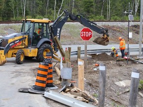 Crews clean up after tractor-trailer flipped, spilling logs on Highway 144 in Greater Sudbury, Ontario on Tuesday, June 2, 2020.