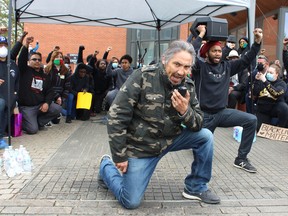 Chief Allan Adam of the Athbasca Chipewyan First Nation takes a knee while speaking at an anti-racism protest supporting Black Lives Matter at Jubilee Plaza in Fort McMurray on Saturday, June 6, 2020. Vincent McDermott/Fort McMurray Today/Postmedia Network