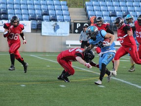 The Fort McMurray Monarchs offense tries to avoid being tackled as they make a play for the end zone in their game against the Alberta Central Buccaneers on June 2, 2018, at Shell Place in Fort McMurray, Alta. Laura Beamish/Fort McMurray Today/ Postmedia Network