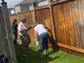 Powell Road neighbours helped clean racist graffiti from a fence that faced the Binns family home last weekend.