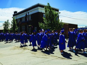 Highwood High School's graduating class last year paraded down the street in their gowns June 28, 2019 from the Museum of the Highwood to George Lane Park, where the graduation ceremony took place.