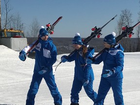Joey Gouthro (left) and Mia Patterson (centre) walk with their coach Sue  Greenberg in their Arctic Winter Games uniforms. Supplied image/ Kathi Brewer-Gouthro