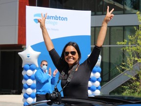 Diane Queiroz takes part in a graduate celebration parade hosted Wednesday at Lambton College. About 500 recent graduates and their families drove through the college campus and received a gift to mark their success. The college's traditional convocation was cancelled due to COVID-19.