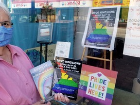 Joan Beecroft holds her latest book, plus her first, just before a Facebook Live launch of 20/20 Hindsight: Being Gay* in Bruce and Grey, Saturday, June 20, 2020, at The Ginger Press in Owen Sound, Ont. (Scott Dunn/The Sun Times/Postmedia Network)