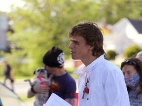 Nathan Rosevear, a resident of the Belle Park tent community, speaks to city staff at an outdoor meeting at the park on Monday. (Meghan Balogh/The Whig-Standard)