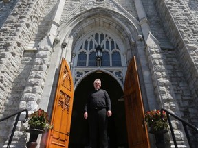 Father Shawn Hughes welcomed parishioners back to St. Mary's Cathedral for the first time in three months on Sunday during a "trial run" service, and officially reopened for mass on Monday. (Meghan Balogh/The Whig-Standard)