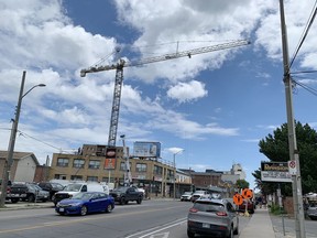 A construction crane looms over a building site on Princess Street in Kingston on June 24, 2020. (Elliot Ferguson/The Whig-Standard)