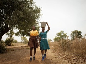 Students in the Upper East Region of Ghana walk 15-minutes away from their school to collect water from a shared borehole. Eliza Powell/WaterAid