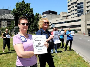 Approximately 40 members of CUPE 1974 and staff members at Kingston Health Sciences Centre's Kingston General Hospital gather across King Street from the emergency department entrance on Wednesday to support workers who are not getting the extra $4 per hour pandemic pay from the province. (Ian MacAlpine/The Whig-Standard)