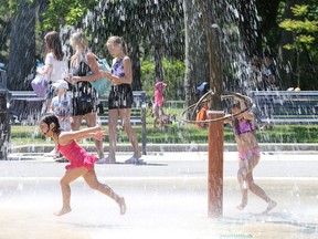 Kingston-area children were able to beat the heat, while trying to observe physical distancing, by playing at one of the city's eight open splash pads. At Lake Ontario Park on Friday morning, about 20 children were dashing through the water features. (Ian MacAlpine/The Whig-Standard)