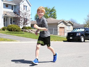 Vincent Kotuk, 6, shows how he ran up and down a hill 100 times in front of his home in Amherstview on May 20 and 21 to raise money for front-line workers helping to battle COVID-19. (Ian MacAlpine/The Whig-Standard)
