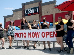 With the province loosening some of its COVID-19 restrictions, restaurants and bars have been able to expand their patios to serve customers while also practicing social distancing. Exeter's Crabby Joe's opened its expanded patio June 18. While indoor seating is still not permitted, Crabby Joe's is offering takeout in addition to its patio service. From left are Missy Dinney, owner Carol Kaumanns, Lisa Thyssen, Anastasiya Kubrak, Nicole Kaumanns, Jenna Becker and Aleaha Reymer. Scott Nixon