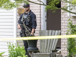 A member of Sarnia police department's emergency response team guards the scene of a shooting at 1971 Franklin Ave. in Brights Grove, Ont. on Friday, June 26, 2020. Police said a 50-year-old victim was taken to hospital in critical condition. Police said the victim was targeted specifically by the shooter. (DEREK RUTTAN, Postmedia Network)