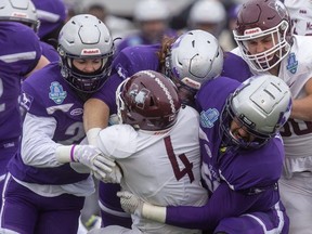 Western Mustangs' Zach Lindley, left, of Chatham, Ont., Tony Rossi and Deointe Knight combine to tackle Justice Allin of the McMaster Marauders during the Yates Cup championship game Saturday, Nov. 9, 2019, in London, Ont.  McMaster dominated the game winning 29-15. Mike Hensen/The London Free Press/Postmedia Network