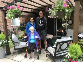 Lilly Balazs, 86, her son Howard Yuhasz and his girlfriend Tammy Joudrey, in Balazs's rule-breaking pergola which has given the senior the chance to visit safely with extended family recently at her Dundas Street apartment building and landed her with an eviction order..