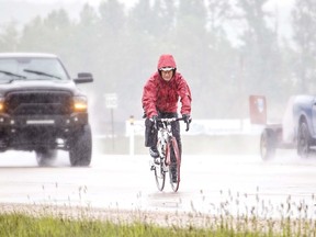 Len Spratt cycled along Highway 43 Sunday despite the rainy conditions. 
Brigette Moore