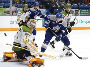 Matej Pekar, right, of the Sudbury Wolves, looks for the puck in front of Joe Vrbetic, of the North Bay Battalion, during OHL action at the Sudbury Community Arena in Sudbury, Jan. 24. 
John Lappa/Sudbury Star/Postmedia