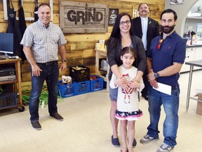 The Guzman family – Kristi, Pedro and their daughter Gabriella – recently donated $820 to The Grind Pembroke to help provide meals at the Community Kitchen, which is offering takeout during the COVID-19 pandemic. Accepting the donation were Jerry Novack (left), The Grind Pembroke executive director and Deacon Adrien Chaput, a member of the Community Kitchen board of directors.