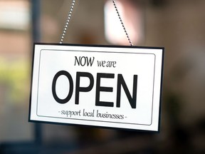 Reopening of a small business activity after the covid-19 emergency, ended the lockdown and quarantine. A business sign that says now we are open support local businesses on cafe or restaurant hang on door at entrance. Close up of open sign on the window of shop or store.

Property Released (PR)