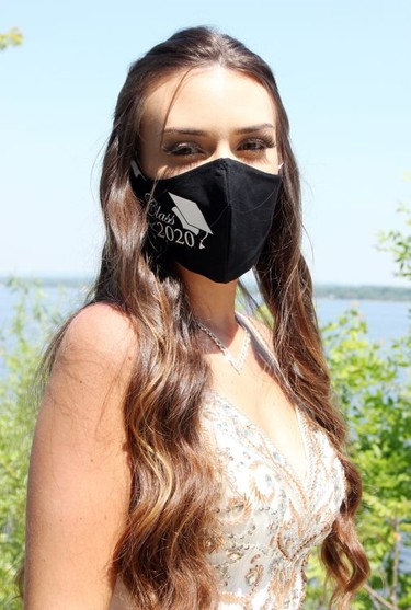 Rachel Williams models a Class of 2020 face mask during the prom photo shoot at the Pembroke Marina for graduates from Fellowes High School.