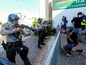Los Angeles County sheriff's deputies fire pepper balls, flash-bangs and rubber bullets to demonstrators in a protest against the death of 18-year-old Andres Guardado and racial injustice, in Compton, California, U.S., June 21, 2020. REUTERS/Ringo Chiu