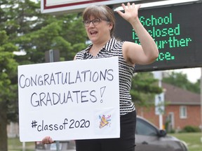 Stratford District secondary school teacher Karen Congram congratulates graduating students who stopped by the high school Friday afternoon to pick up grad bags. CORY SMITH